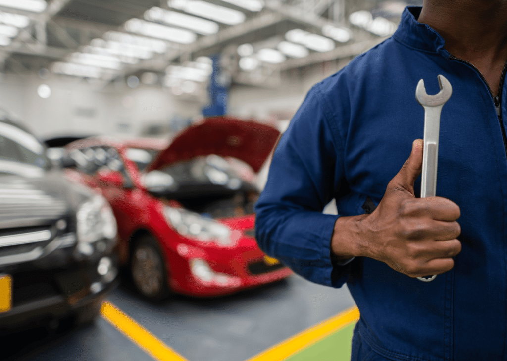 Mechanic holding a wrench in a garage